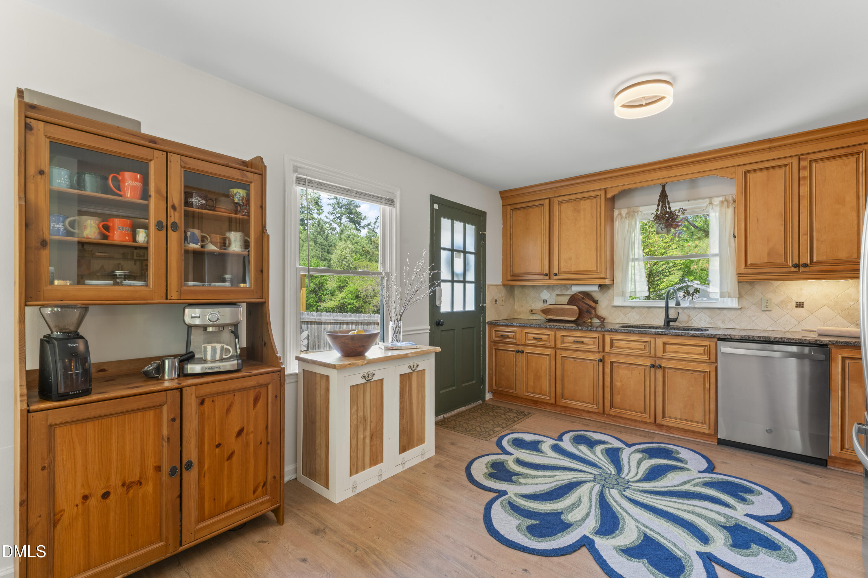 3419 Old Chapel Hill Road Durham, NC 27707 - Photo 16 of 38 a kitchen with stainless steel appliances granite countertop a stove a sink and a refrigerator