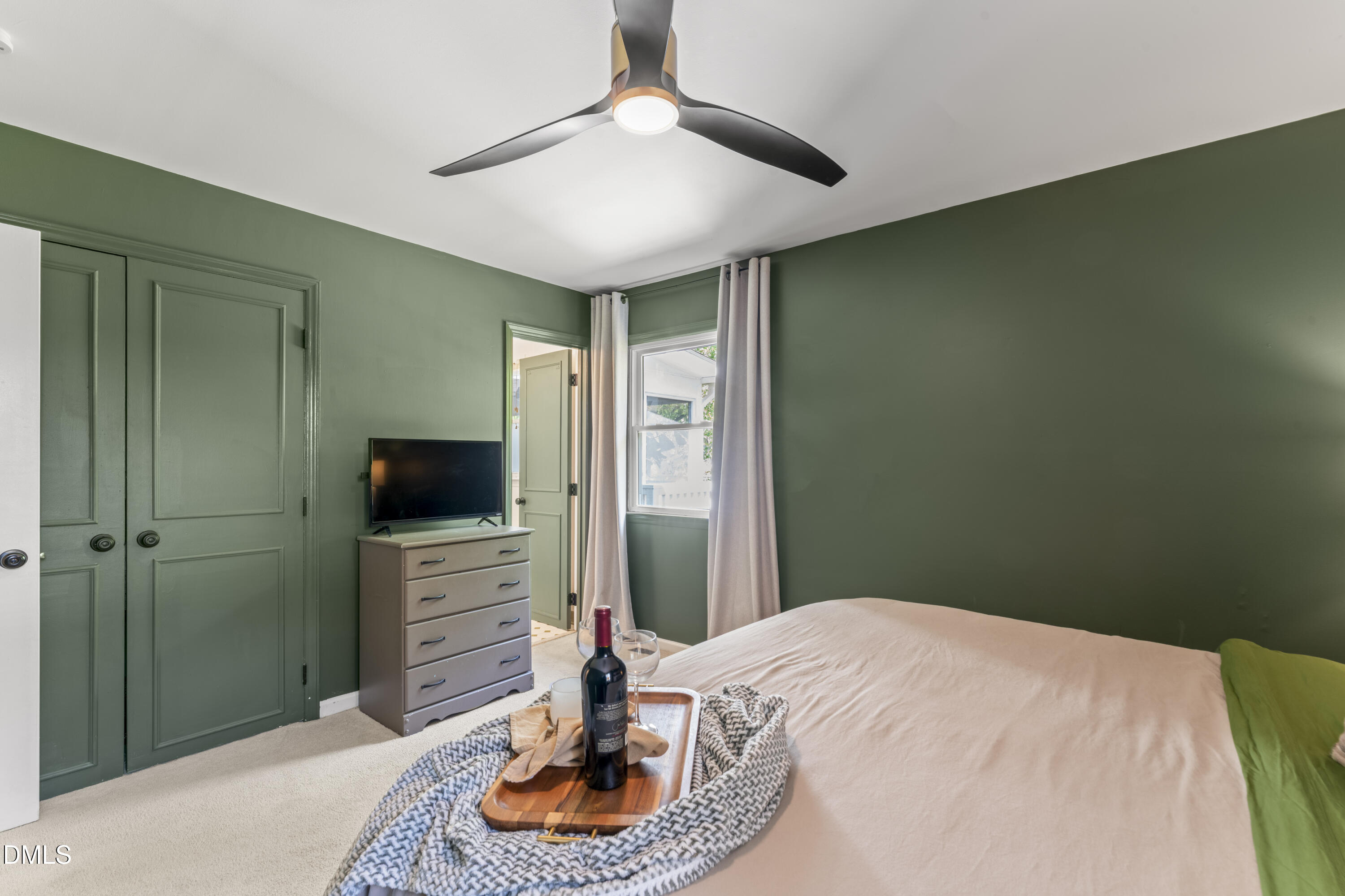 3419 Old Chapel Hill Road Durham, NC 27707 - Photo 23 of 38 a bedroom with a bed and a flat screen tv
