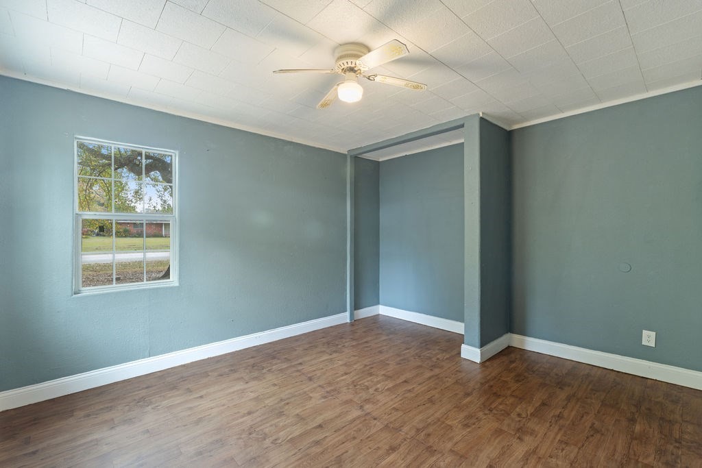 2915 Freeman Street Lufkin, TX 75901 - Photo 21 of 31 an empty room with wooden floor and windows