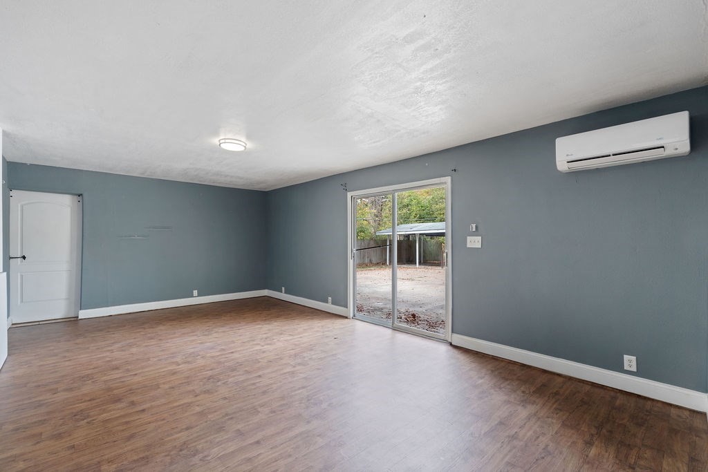 2915 Freeman Street Lufkin, TX 75901 - Photo 25 of 31 an empty room with wooden floor and windows