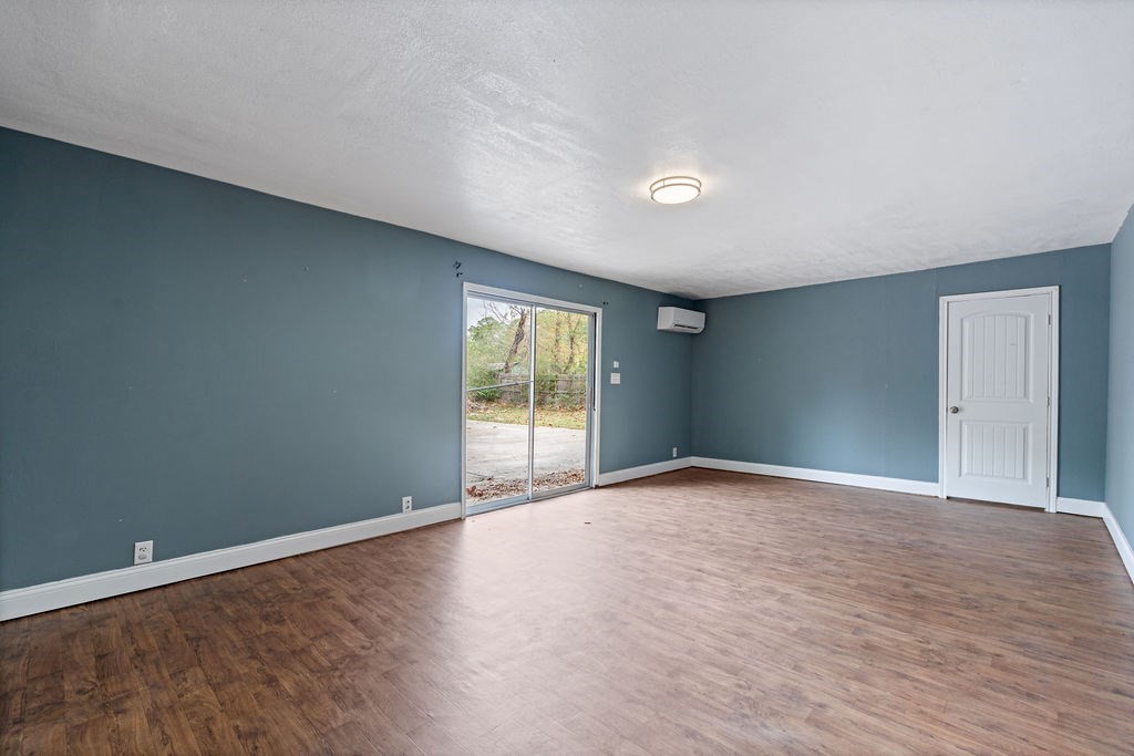 2915 Freeman Street Lufkin, TX 75901 - Photo 26 of 31 a view of an empty room with wooden floor and a window