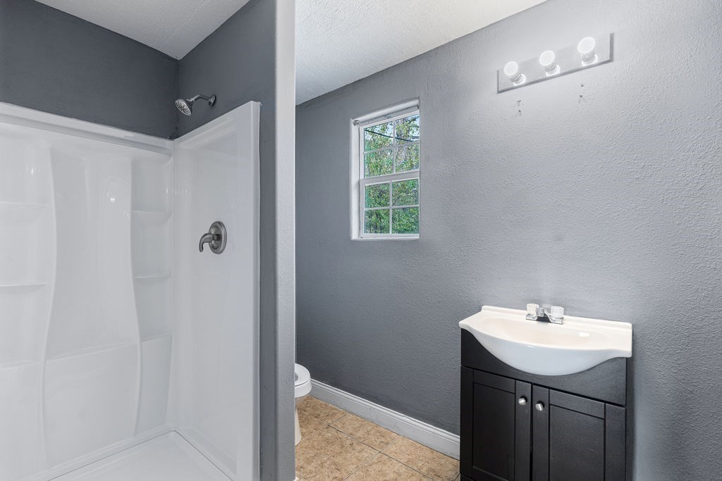 2915 Freeman Street Lufkin, TX 75901 - Photo 28 of 31 a bathroom with a sink toilet and shower