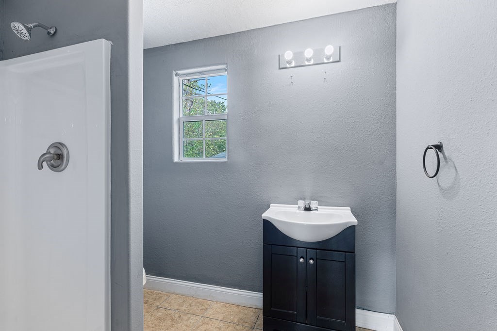 2915 Freeman Street Lufkin, TX 75901 - Photo 29 of 31 a bathroom with a sink a mirror and shower