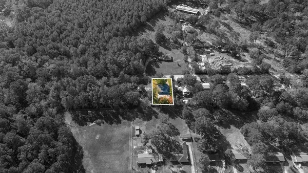a aerial view of a house with a yard