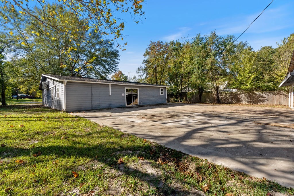 2915 Freeman Street Lufkin, TX 75901 - Photo 9 of 31 a backyard of a house with table and chairs under an umbrella
