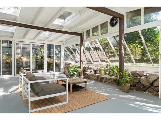 a building outdoor space with patio furniture and potted plants