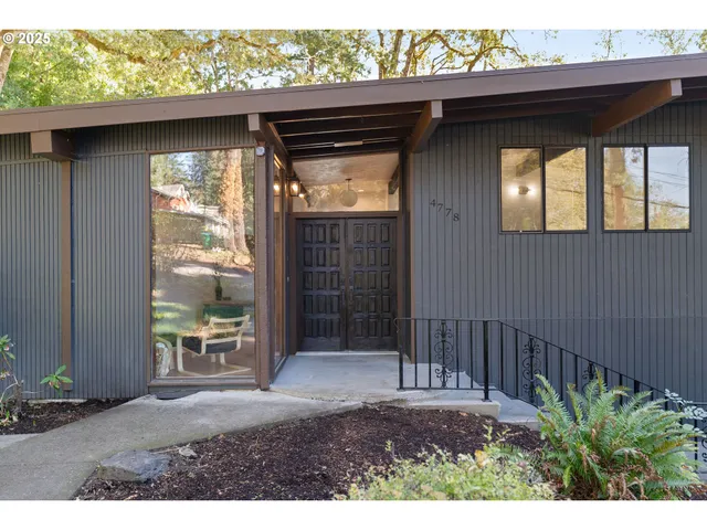 a backyard of a house with table and chairs