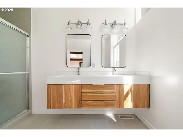 a bathroom with a shower a sink and a mirror