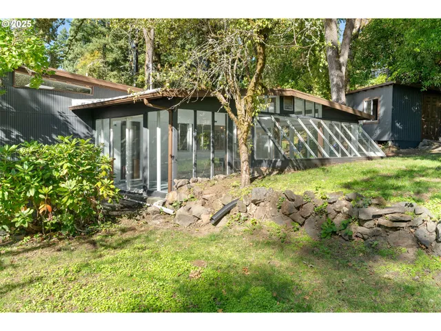 a view of a house with a backyard