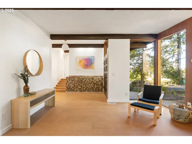 a living room with furniture and a floor to ceiling window