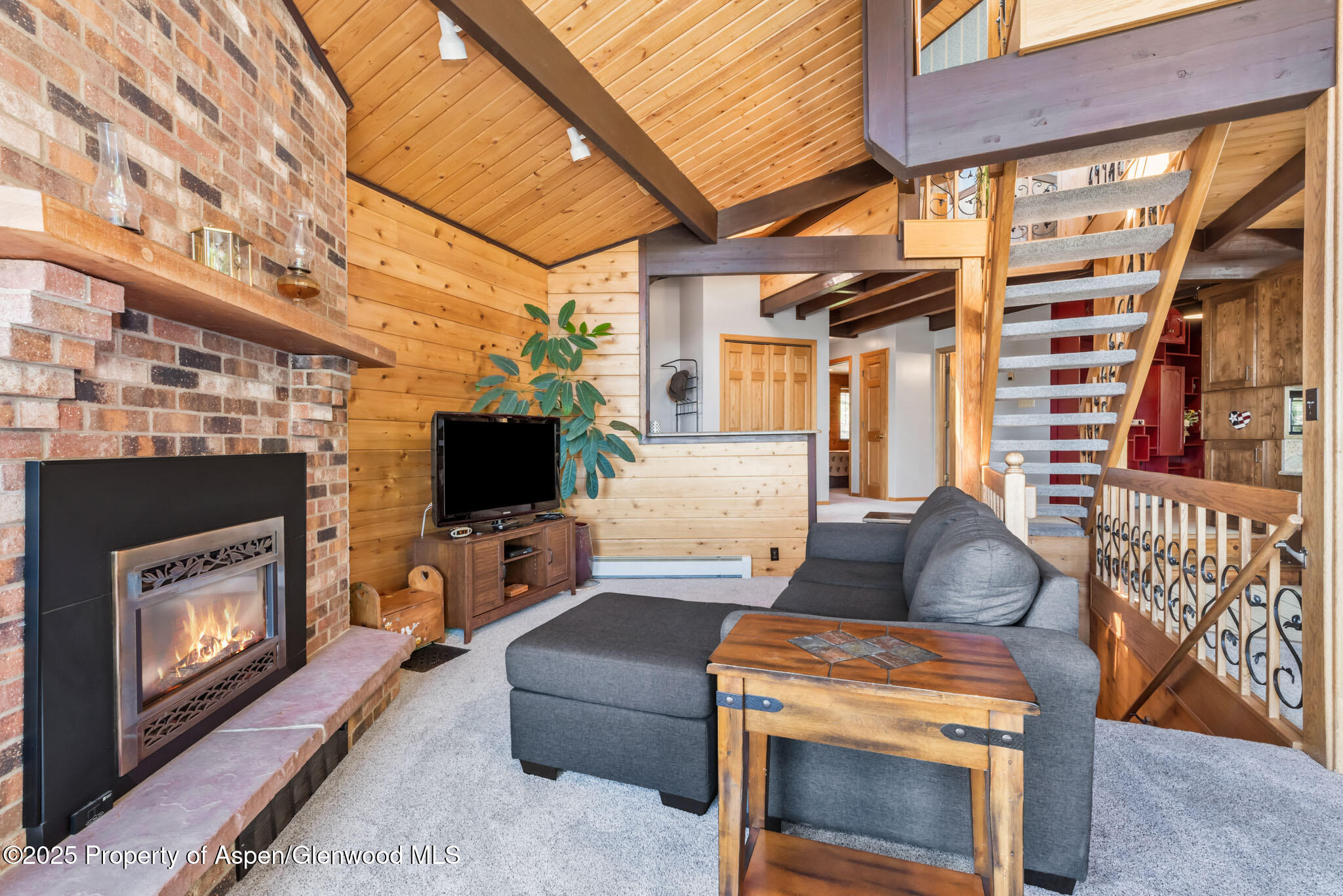 922 Steele Court Craig, CO 81625 - Photo 17 of 115 a living room with furniture a flat screen tv and a fireplace