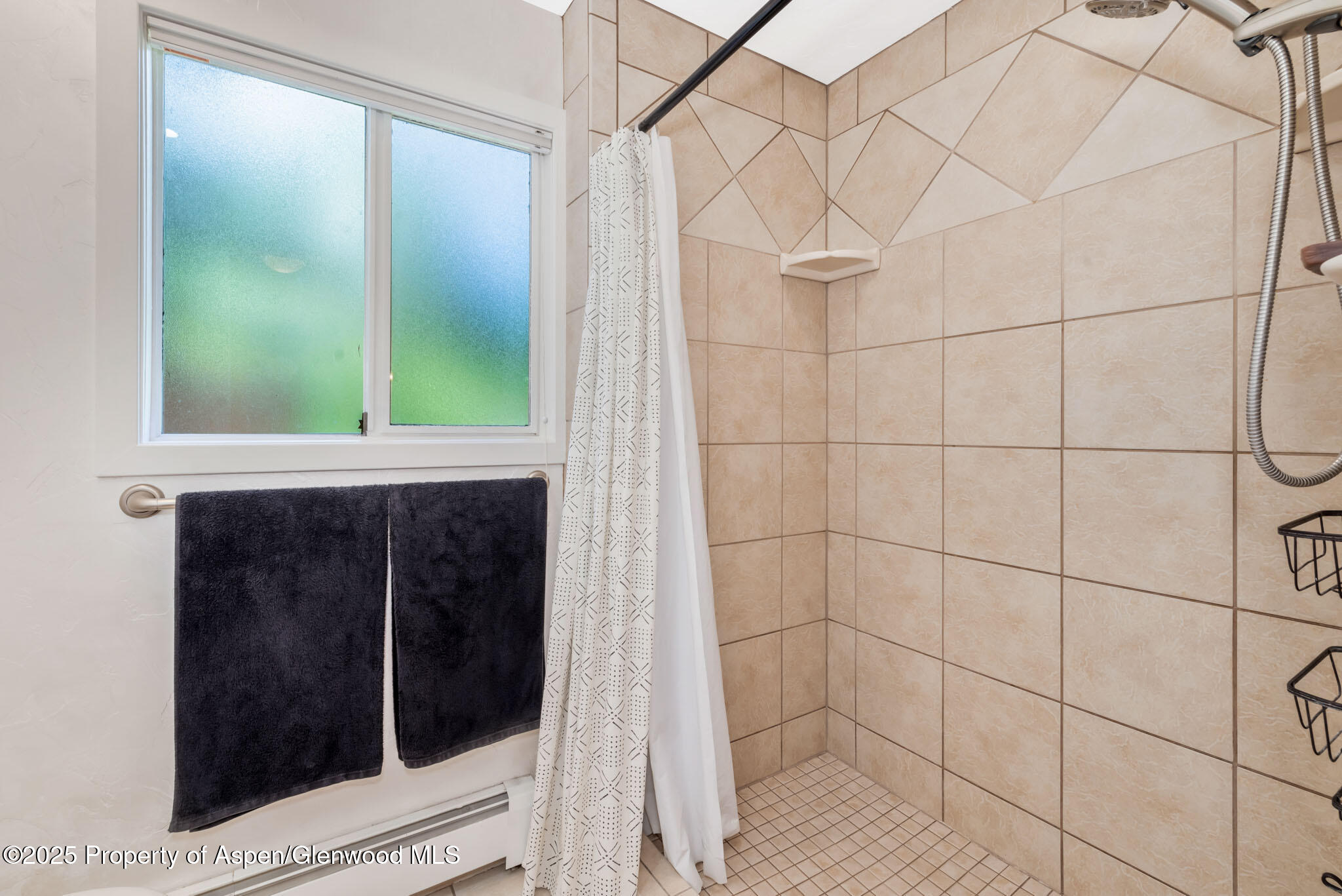 922 Steele Court Craig, CO 81625 - Photo 39 of 115 a bathroom with a shower and a window
