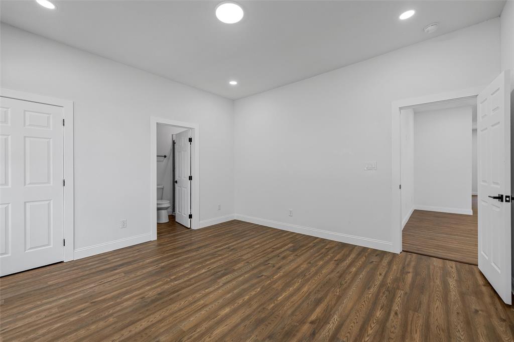 2023 Bosque Boulevard Waco, TX 76707 - Photo 13 of 26 Spacious room featuring wood-finish flooring, white walls, and recessed lighting
