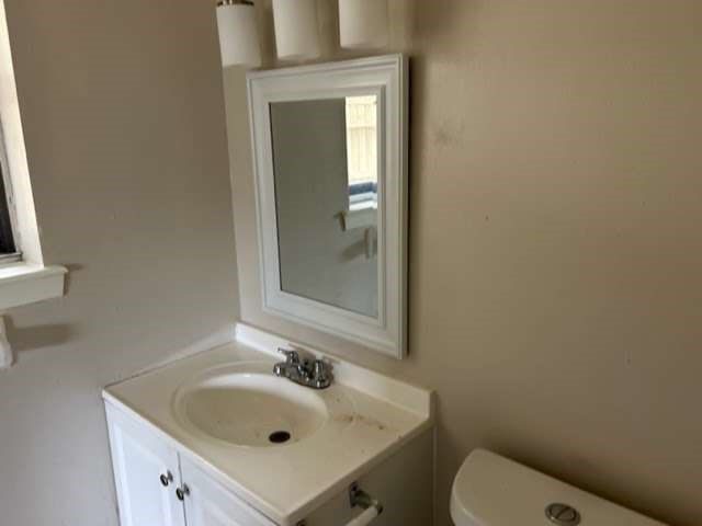1200 Rugeley Street Bay City, TX 77414 - Photo 11 of 16 a bathroom with a sink a toilet and mirror