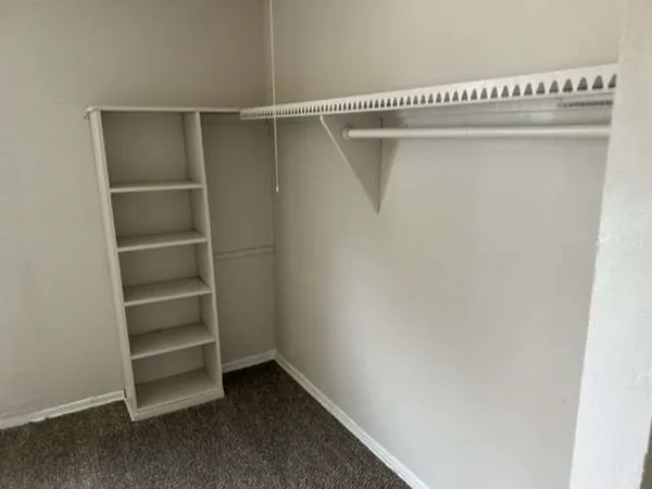 a view of bedroom with window and cabinet