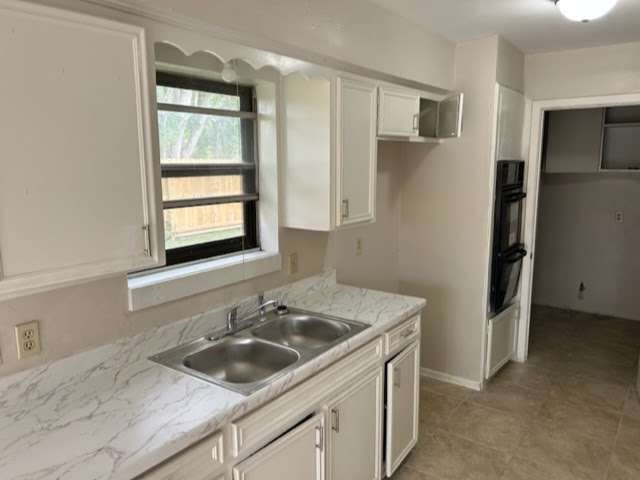 1200 Rugeley Street Bay City, TX 77414 - Photo 9 of 16 a kitchen with a sink stove and refrigerator