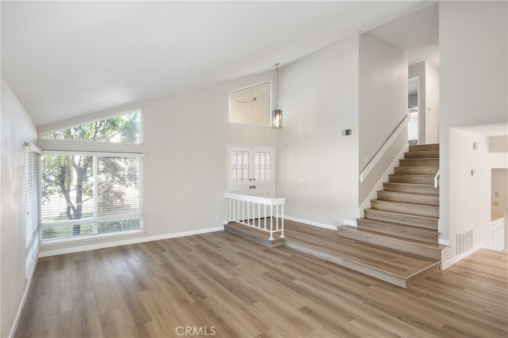 2 Glorieta East Irvine, CA 92620 - Photo 2 of 23 a view of an empty room with wooden floor and a window
