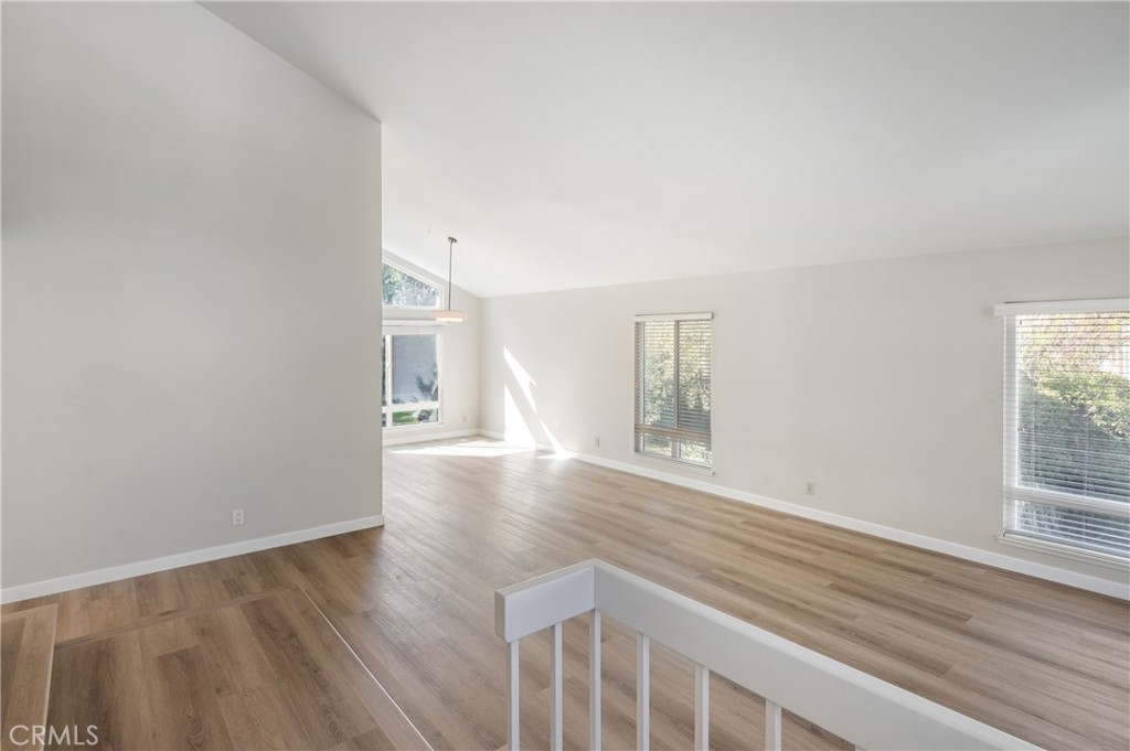 2 Glorieta East Irvine, CA 92620 - Photo 3 of 23 an empty room with wooden floor and windows