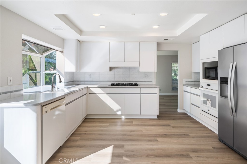 2 Glorieta East Irvine, CA 92620 - Photo 5 of 23 a kitchen with white cabinets and white appliances