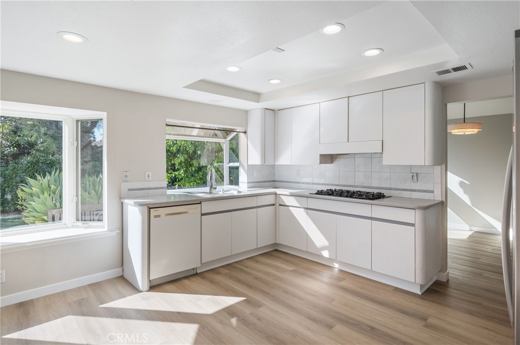 2 Glorieta East Irvine, CA 92620 - Photo 6 of 23 a kitchen with granite countertop white cabinets and white appliances