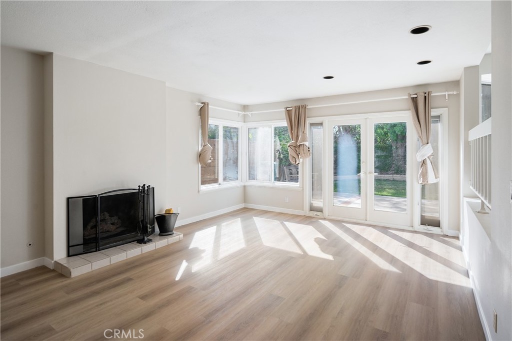 2 Glorieta East Irvine, CA 92620 - Photo 8 of 23 a view of an empty room with wooden floor fireplace and a window