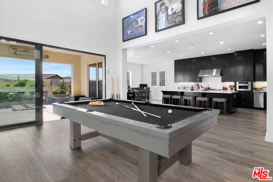 20234 Jubilee Way Porter Ranch, CA 91326 - Photo 12 of 30 a room with table chairs and a large window