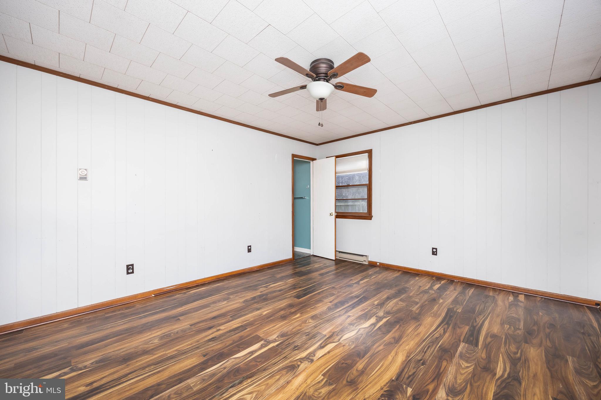 310 Zion Road Salisbury, MD 21804 - Photo 27 of 40 an empty room with wooden floor fan and windows