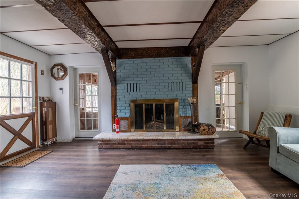 71 Kawlija Road Grahamsville, NY 12740 - Photo 3 of 16 a living room with furniture windows and a fireplace