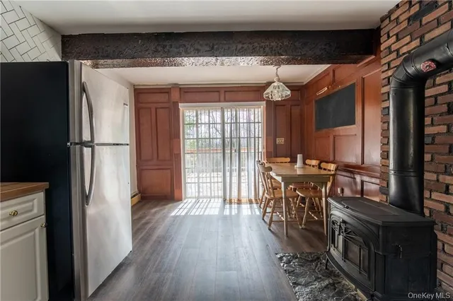 a kitchen with kitchen island a counter top space a sink a refrigerator and a cabinets