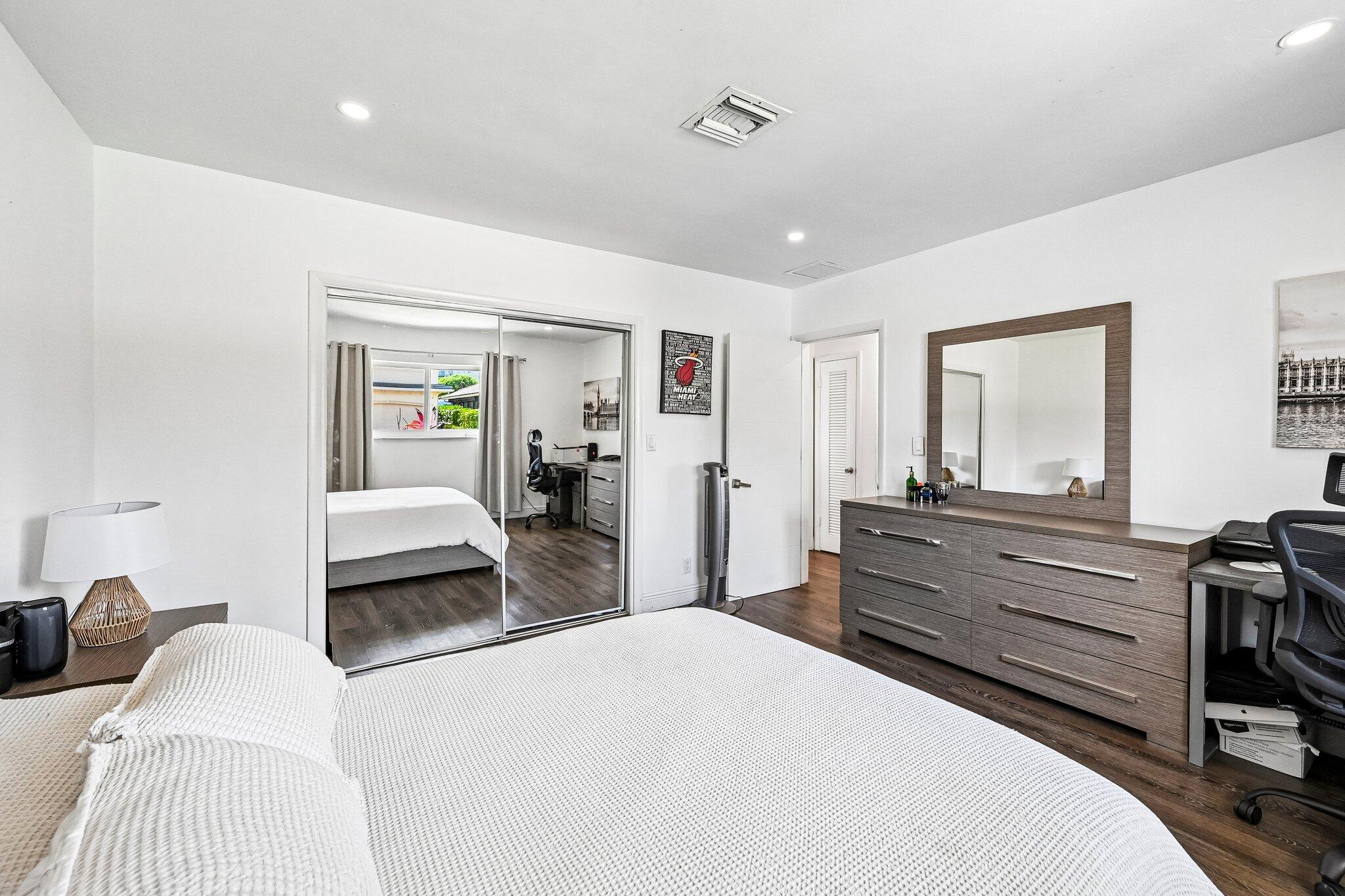 2940 Northeast 39th Court Lighthouse Point, FL 33064 - Photo 25 of 42 a bedroom with a bed and wooden floor