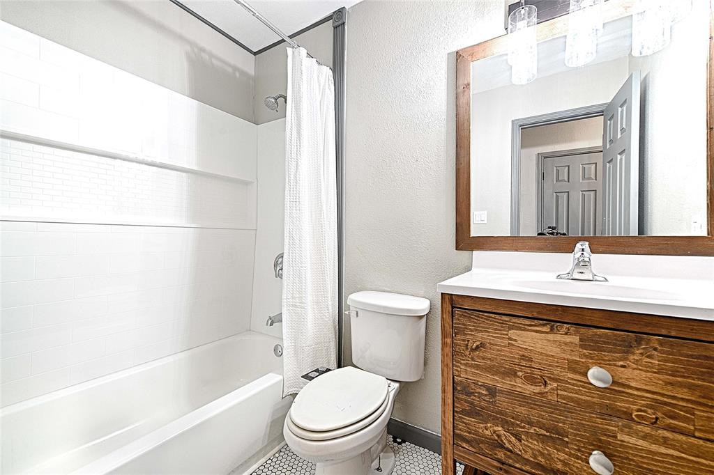 4805 Hunters Ridge Drive Sachse, TX 75048 - Photo 16 of 24 a bathroom with a sink toilet and shower