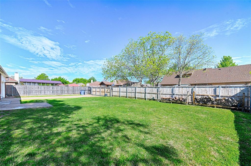 4805 Hunters Ridge Drive Sachse, TX 75048 - Photo 21 of 24 a view of yard with swimming pool and green space