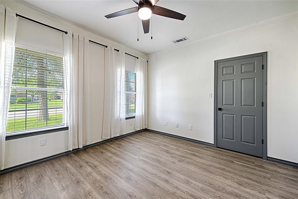 4805 Hunters Ridge Drive Sachse, TX 75048 - Photo 8 of 24 a view of an empty room with a window and wooden floor