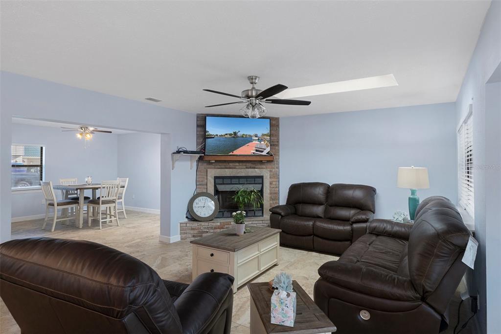4964 Cedarbrook Lane Hernando Beach, FL 34607 - Photo 13 of 29 a living room with furniture and a fireplace