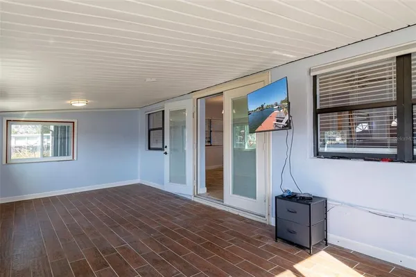 a view of a livingroom with wooden floor and windows