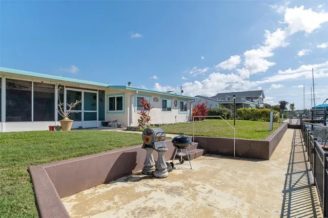 a view of a house with a backyard porch and sitting area