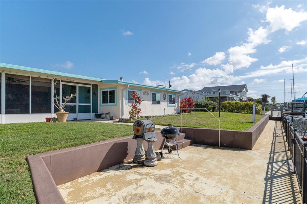 4964 Cedarbrook Lane Hernando Beach, FL 34607 - Photo 26 of 29 a view of a house with a backyard porch and sitting area