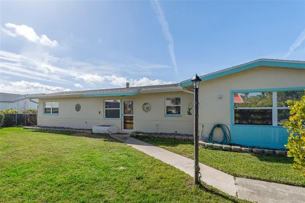 a view of a house with a yard and plants