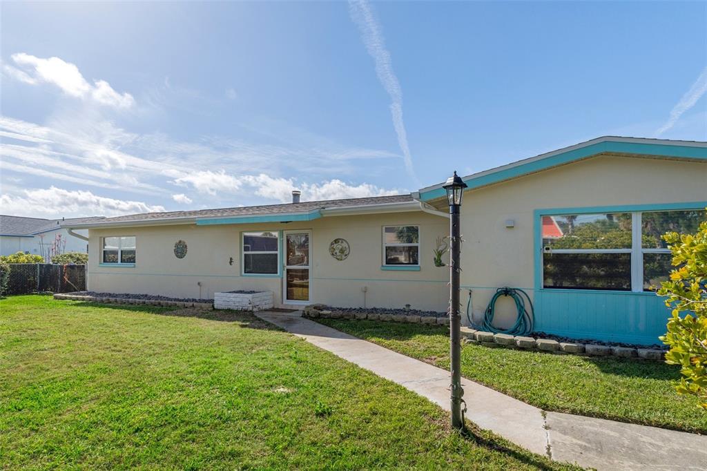 4964 Cedarbrook Lane Hernando Beach, FL 34607 - Photo 5 of 29 a view of a house with a yard and plants