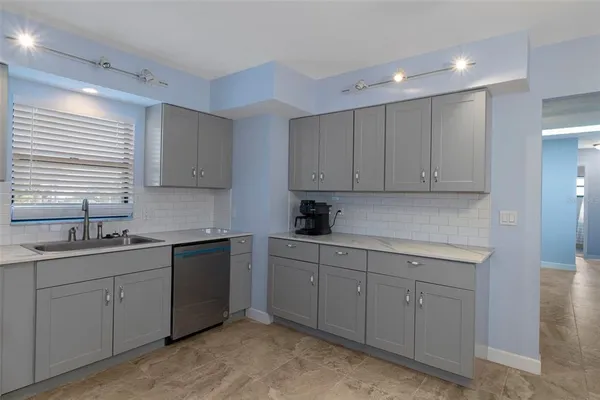 a kitchen with sink and cabinets
