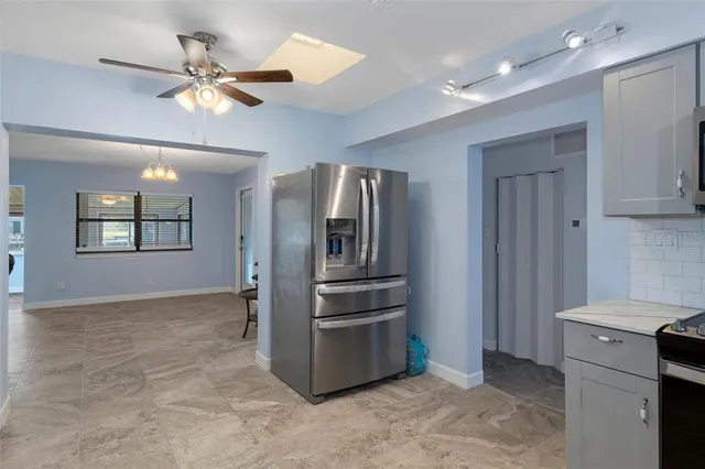 a kitchen with a refrigerator and a sink