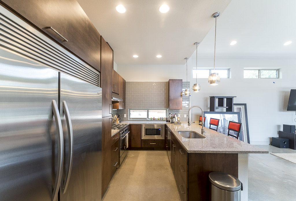 2501 East 9th Street Austin, TX 78702 - Photo 5 of 38 a kitchen with kitchen island a refrigerator and a sink