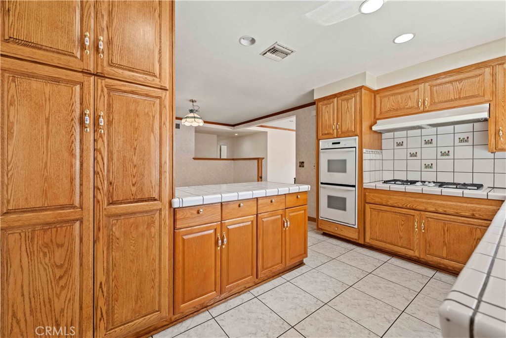6664 Tapley Street Simi Valley, CA 93063 - Photo 3 of 31 Kitchen w/tile counter tops, double door pantry & recessed lighting.