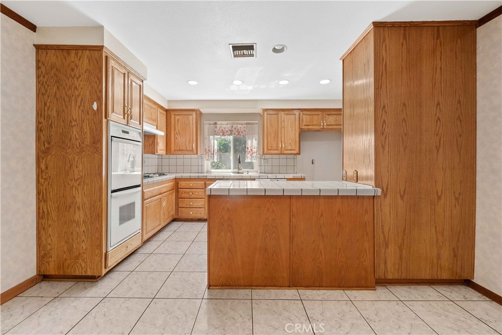 6664 Tapley Street Simi Valley, CA 93063 - Photo 4 of 31 Kitchen with tile countertops & built-in appliances.