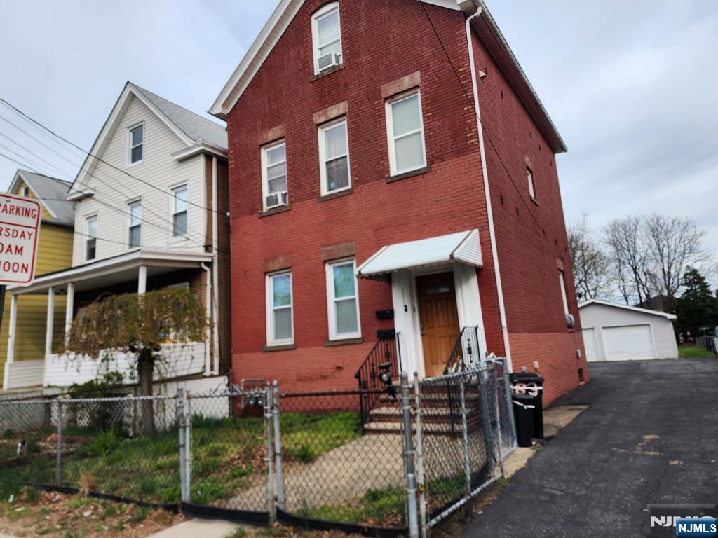 83 Plauderville Avenue Garfield, NJ 07026 - Photo 2 of 2 front view of a house with a yard