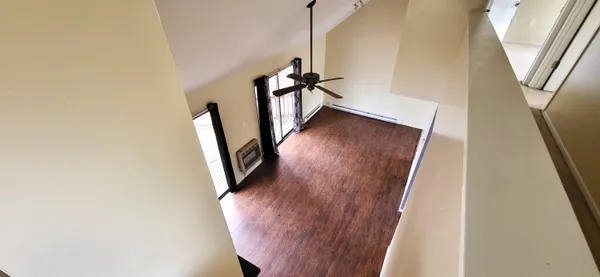 a view of a hallway with wooden floor