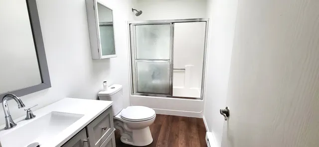 a bathroom with a toilet sink and shower