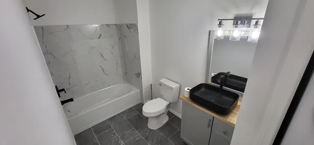 a bathroom with a toilet and a shower