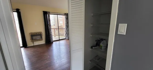 a view of hallway with walk in closet and bathroom