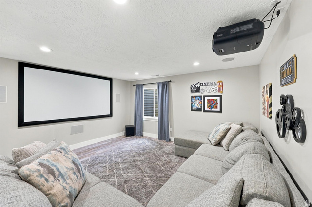615 West 1870th Street South Payson, UT 84651 - Photo 14 of 31 Dedicated media room featuring a large projection screen, mounted projector, recessed lighting, and wall-mounted speakers